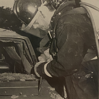 A firefighter using a Superior Pneumatic safety tool to cut into a car